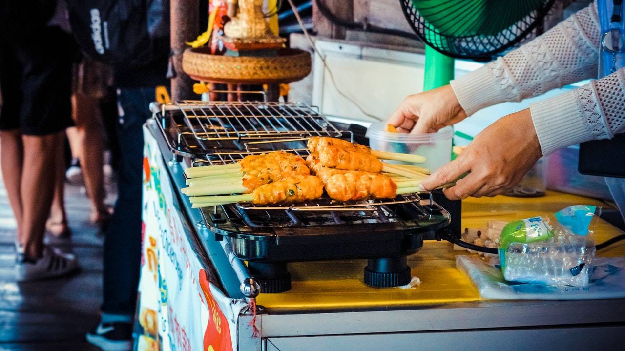 A person selling satay on the streets - gibx malaysia scam